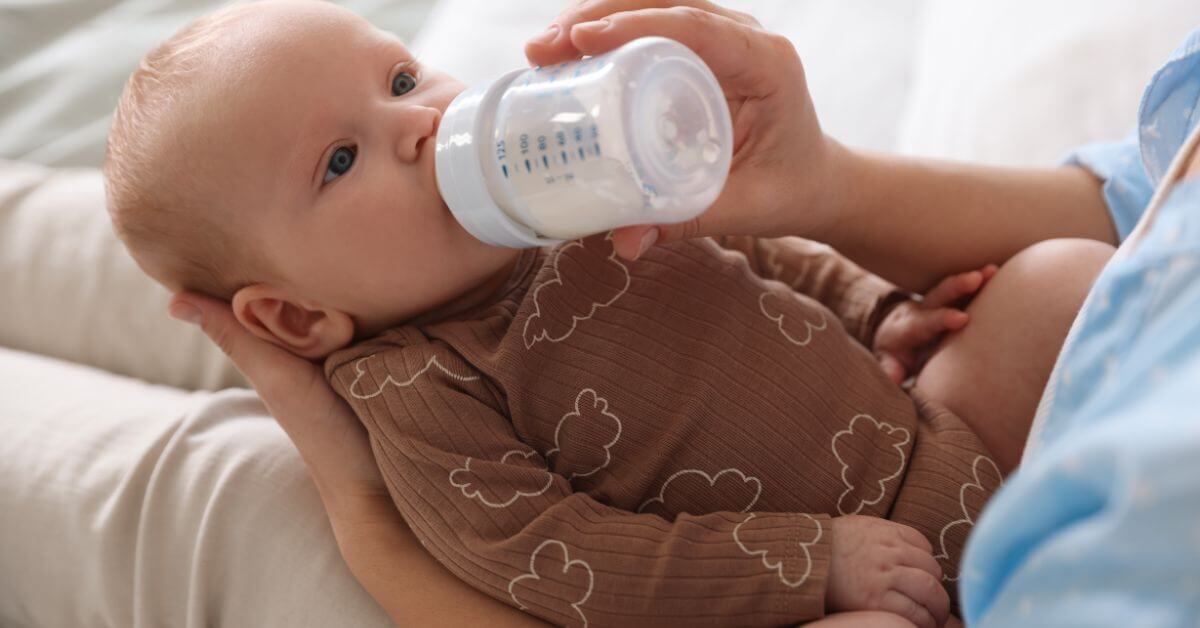 Baby being bottle-fed formula milk by parent - SMA infant formula recall toxin contamination